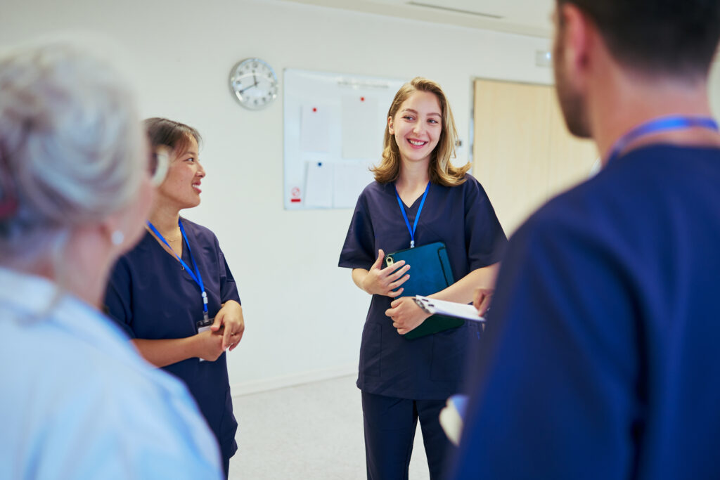 Doctors and nurses collaborating, sharing expertise, and coordinating patient care during a productive meeting in a modern hospital setting