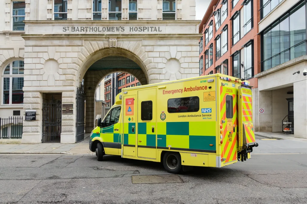 NHS London Ambulance Service emergency ambulance parked outside St Bartholomew's Hospital in London