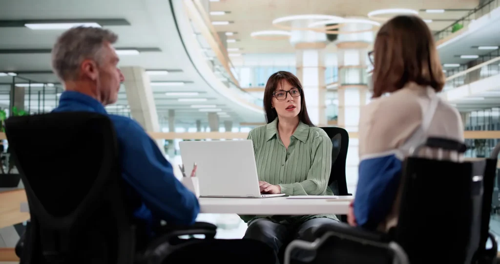 Woman sat behind a laptop in an office setting