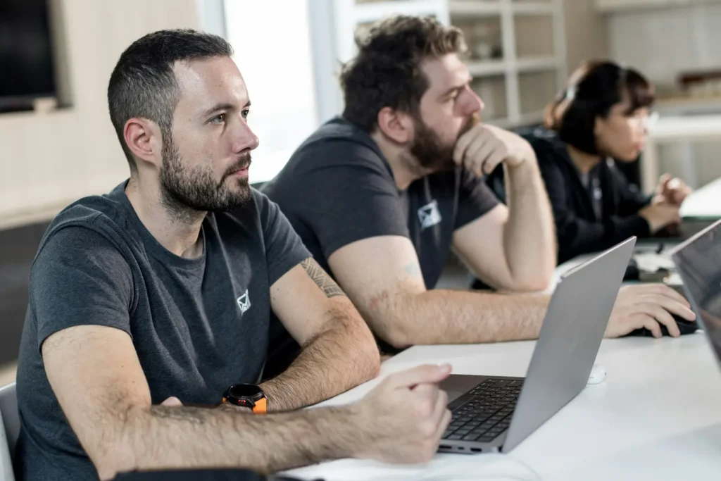 Group of people sat in front of laptops