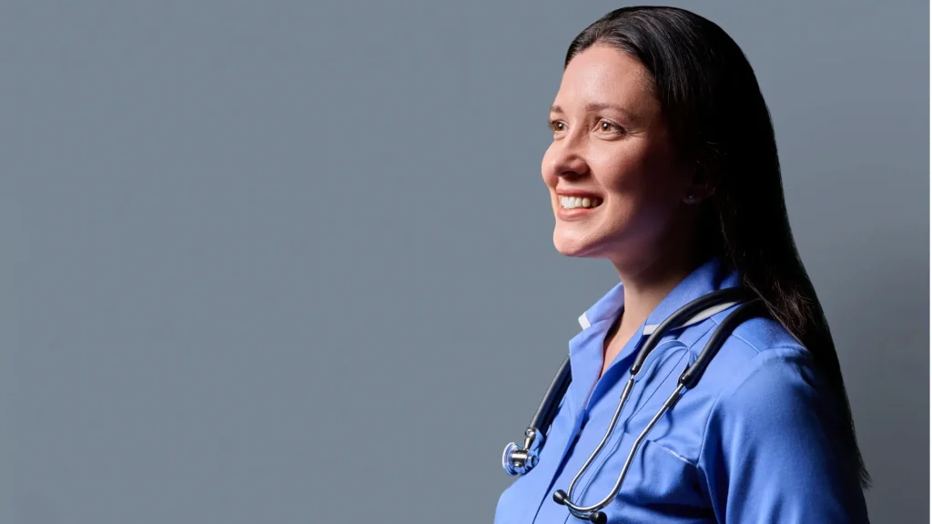 An NHS nurse smiling