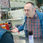 a conflict between an angry man and a shop worker