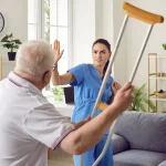 An angry patient threatens a nurse with his walking crutch