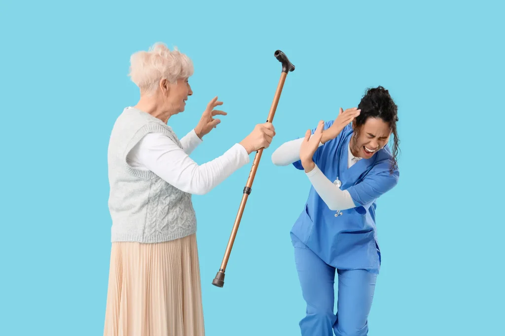 An elderly female patient attacks a nurse with a walking stick