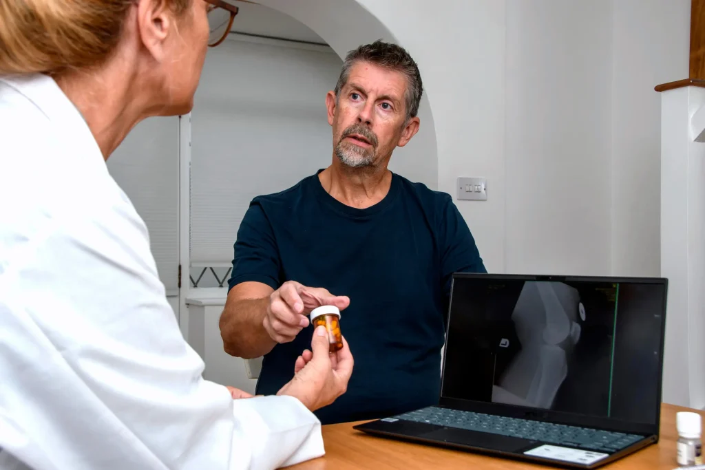 A male patient receives a prescription from his doctor