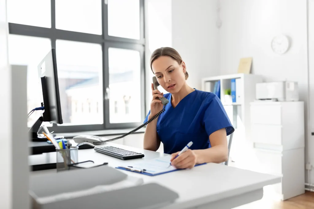 A nurse talks to a frustrated patient on the telephone