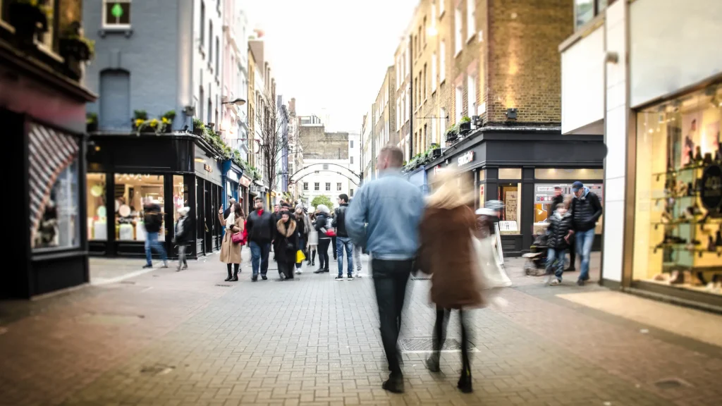 Shoppers on a UK high street, where retail workers face rising levels of violence and abuse