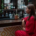 A woman sitting alone at a bar — an everyday scene, and the kind of moment staff safety training is designed to help recognise if circumstances change