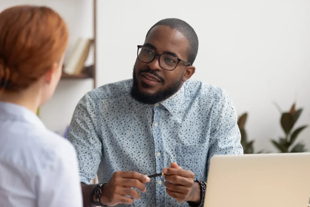 hr officer talking to a member of staff in the office